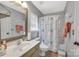 Well-lit bathroom featuring a single sink, framed mirror, and a shower with decorative curtain at 9614 Turning Wheel Dr, Charlotte, NC 28214