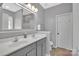 Bathroom with double sink vanity, large mirror, and neutral colored walls and flooring at 9614 Turning Wheel Dr, Charlotte, NC 28214