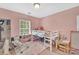 Pink bedroom with bunk bed, shelves, a large window, and a fluffy rug at 9614 Turning Wheel Dr, Charlotte, NC 28214
