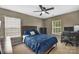 Bedroom with two large windows, ceiling fan and dark wood furnishings at 9614 Turning Wheel Dr, Charlotte, NC 28214