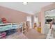 Pink bedroom with bunk bed, shelving and doorway view to the living room at 9614 Turning Wheel Dr, Charlotte, NC 28214