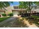 Beautiful home boasting a manicured lawn, mature tree, and a convenient attached one-car garage at 9614 Turning Wheel Dr, Charlotte, NC 28214