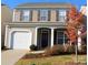 Charming two-story home featuring neutral siding, a single-car garage, and well-maintained landscaping at 9614 Turning Wheel Dr, Charlotte, NC 28214
