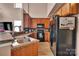 Well-lit kitchen with stainless steel sink, black appliances, and light wood cabinets at 9614 Turning Wheel Dr, Charlotte, NC 28214