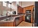 Bright kitchen with a high ceiling, stainless steel sink, black appliances, and plenty of cabinet space at 9614 Turning Wheel Dr, Charlotte, NC 28214