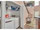 Convenient laundry area with modern machines, storage shelves, and easy access to the main living space at 9614 Turning Wheel Dr, Charlotte, NC 28214