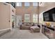 Open living room with a vaulted ceiling, large windows, and a cozy seating area at 9614 Turning Wheel Dr, Charlotte, NC 28214