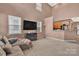 Spacious living room featuring high ceilings, neutral walls, and a view of the open kitchen at 9614 Turning Wheel Dr, Charlotte, NC 28214