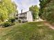 Spacious backyard featuring lush green lawn, trees and a deck; perfect for outdoor activities and relaxation at 100 Willow Run Dr # 26, Gastonia, NC 28056