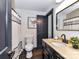 Well-lit bathroom with dark wood vanity, sink, toilet and decorative shower curtain at 100 Willow Run Dr # 26, Gastonia, NC 28056