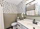 Elegant bathroom featuring leaf wallpaper, wainscoting, and updated fixtures at 100 Willow Run Dr # 26, Gastonia, NC 28056