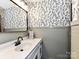 Charming powder room featuring leaf wallpaper, wainscoting, and a modern sink at 100 Willow Run Dr # 26, Gastonia, NC 28056