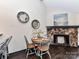 Cozy dining area shows a stone fireplace and stylish wall decor with rustic round table at 100 Willow Run Dr # 26, Gastonia, NC 28056
