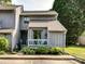 Charming townhome featuring a cozy porch, landscaped garden, and a well-maintained gray wood facade at 100 Willow Run Dr # 26, Gastonia, NC 28056