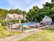 Community pool featuring ample seating, umbrellas, and a secure fenced area for relaxation and recreation at 100 Willow Run Dr # 26, Gastonia, NC 28056