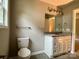 Bright bathroom featuring modern vanity with granite top, toilet, towel bar, and vanity light at 1024 Short St, Salisbury, NC 28144