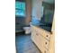 Bathroom with sleek gray floors, white vanity with gray countertop, and modern fixtures at 1024 Short St, Salisbury, NC 28144