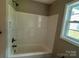 Bathroom showcasing a shower-tub combination with white tile surround and fixtures at 1024 Short St, Salisbury, NC 28144