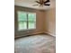 Bright bedroom with a large window, neutral carpet, ceiling fan and freshly painted walls at 1024 Short St, Salisbury, NC 28144