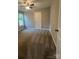 Comfortable carpeted bedroom with ample natural light and a ceiling fan at 1024 Short St, Salisbury, NC 28144