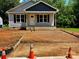 Charming single-story home featuring black shutters, gray siding, and a freshly prepped front yard at 1024 Short St, Salisbury, NC 28144
