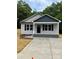 Charming home with gray siding, black shutters, and a new concrete driveway at 1024 Short St, Salisbury, NC 28144