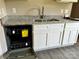 Modern kitchen with stainless steel sink, white cabinets, granite countertops, and an open dishwasher at 1024 Short St, Salisbury, NC 28144