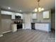 Modern kitchen with white cabinets, stainless steel appliances, granite countertops and wood-look floors at 1024 Short St, Salisbury, NC 28144