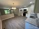 Open concept living room showcasing modern kitchen with white cabinets and stainless steel appliances at 1024 Short St, Salisbury, NC 28144