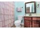 Bathroom featuring pink shower curtain and a wood vanity with white countertop at 10378 Alexander Martin Ave, Charlotte, NC 28277