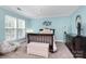 Bedroom with blue walls, a chandelier, black dresser and a window at 10378 Alexander Martin Ave, Charlotte, NC 28277