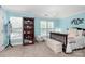 Bedroom with blue walls, a bookshelf, and a window with natural light at 10378 Alexander Martin Ave, Charlotte, NC 28277