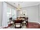 Elegant dining room with a stylish chandelier, round table, and zebra-print rug at 10378 Alexander Martin Ave, Charlotte, NC 28277