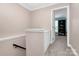 Upstairs hallway with storage cabinet, plush carpet and doorway to the study at 10378 Alexander Martin Ave, Charlotte, NC 28277