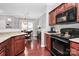 Kitchen and dining area with wood cabinets, hardwood floors, and granite countertops at 10378 Alexander Martin Ave, Charlotte, NC 28277