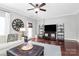 Bright living room with ceiling fan, large clock, and hardwood floors with plenty of space for entertaining at 10378 Alexander Martin Ave, Charlotte, NC 28277