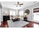 Bright living room with large windows, ceiling fan, and stylish decor, perfect for relaxation and entertaining at 10378 Alexander Martin Ave, Charlotte, NC 28277