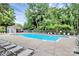 Large, clear pool with lounge chairs and ample seating surrounded by lush landscaping at 10378 Alexander Martin Ave, Charlotte, NC 28277