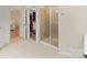 Spacious bathroom featuring a glass-enclosed shower, access to a walk-in closet, and light tile flooring at 1104 Snowbird Ln, Waxhaw, NC 28173