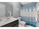Cozy bathroom featuring blue patterned shower curtains and a traditional vanity at 1104 Snowbird Ln, Waxhaw, NC 28173