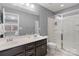 Bathroom featuring a double vanity, a glass-enclosed shower, and modern fixtures at 1104 Snowbird Ln, Waxhaw, NC 28173