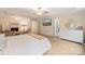 Large bedroom with a sitting area with fireplace, decorative headboard, and ample lighting at 1104 Snowbird Ln, Waxhaw, NC 28173