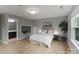 Bright bedroom featuring wood floors, gray walls, and an ensuite bathroom at 1104 Snowbird Ln, Waxhaw, NC 28173