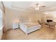 Spacious bedroom featuring a decorative headboard, ceiling fan, and sitting area with a fireplace at 1104 Snowbird Ln, Waxhaw, NC 28173