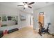 Bright exercise room complete with work-out equipment, mirrors, and mounted TV at 1104 Snowbird Ln, Waxhaw, NC 28173