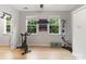 Bright exercise room complete with work-out equipment, mirrors, and natural light at 1104 Snowbird Ln, Waxhaw, NC 28173