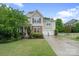 Charming two-story home with stone accents, manicured lawn, and a two-car garage at 1104 Snowbird Ln, Waxhaw, NC 28173