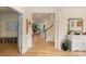 Bright foyer with hardwood floors, staircase, and views into the living spaces at 1104 Snowbird Ln, Waxhaw, NC 28173