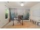 Well-lit office with a nature-themed accent wall, desk, and ample storage at 1104 Snowbird Ln, Waxhaw, NC 28173