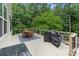 Outdoor patio featuring a dining area, grill, and wooded views, perfect for outdoor gatherings at 1104 Snowbird Ln, Waxhaw, NC 28173